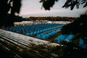 a row of blue chairs in a field at Munich Oktoberfest ESN Campsite with Breakfast! in Munich