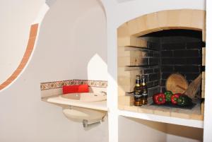 a bathroom with a brick fireplace and a sink at Apartment Capri by Algarve Vacation in Albufeira