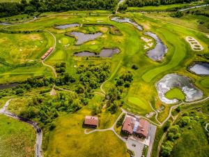 an overhead view of a golf course with water reservoirs at National Golf Resort in Klaipėda