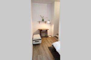 a room with a bed and a table in it at Appartement cosy proche du CHU in Rouen