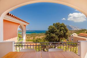 a view from the balcony of a house with a table and chairs at Residence Hotel Lu Nibareddu in San Teodoro