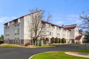 a large white building with a road in front of it at Red Roof Inn PLUS+ Boston - Logan in Saugus