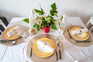 a white table with plates and napkins on it at Flozed in Beauvais