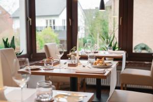 a table with plates of food and wine glasses at Bio-Hotel Melter in Bad Laer