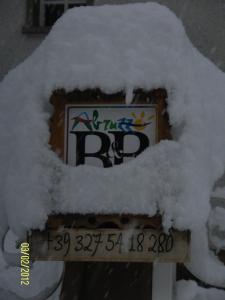 a sign covered in snow on top at La Villa in Pratola Peligna
