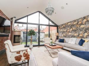 a living room with a couch and a table at Westwood House in Lytham St Annes