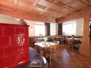 a restaurant with tables and a bird sitting on top of a red cabinet at Hotel Alla Rocca in Varena