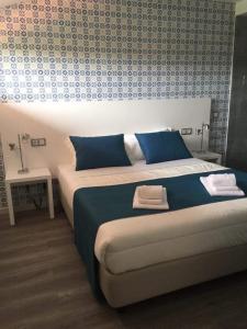 a bedroom with a large bed with two towels on it at PinoyHouse Fatima in Fátima