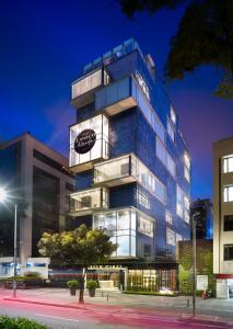 a large building with a clock on the side of it at The Click Clack Hotel Bogotá in Bogotá