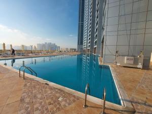 a large swimming pool in the middle of a building at Luxury 1 BR Beach Apartment with Full Sea View in Ajman 