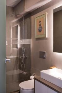 a bathroom with a shower and a toilet and a sink at SYNATHENS APARTMENTS & STUDIOS in Athens