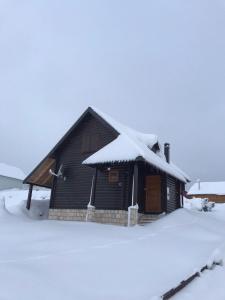 a house with snow on the roof of it at Durmitorska kuća in Žabljak