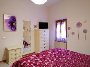 a bedroom with a bed and a dresser and a window at A casa di Iole tra il Chianti e la bella Firenze in Florence