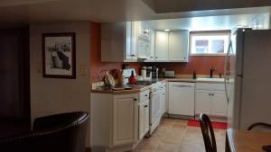 a kitchen with white cabinets and a refrigerator at 4047 Wyandot Street in Denver