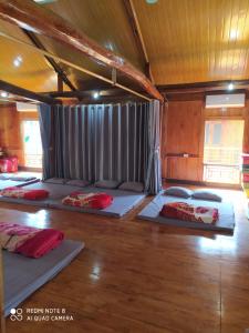 a room with four beds on the floor at Cò's House in Mai Châu