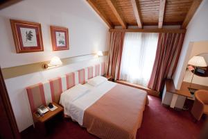 Posteľ alebo postele v izbe v ubytovaní Eurohotel Palace Maniago
