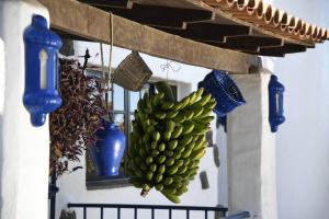 a bunch of green bananas hanging from a wall at Finca Angelus Apartment Syrah with Amazing Views in La Matanza de Acentejo