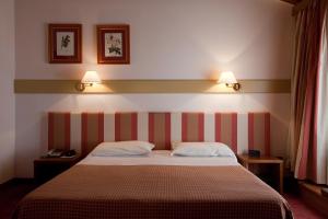 Posteľ alebo postele v izbe v ubytovaní Eurohotel Palace Maniago