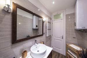 a bathroom with a sink and a mirror at Apartman Arca in Rovinj +17 photos