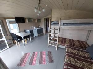 a small room with a bed and a desk at Guest House Podnieki in Ventspils