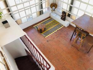 an overhead view of a staircase with a table and a rug at Casa Palacio, Arte e Historia in Buenos Aires
