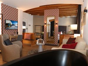 a living room with a couch and a mirror at Hotel Parsenn in Davos