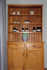 a wooden cabinet with a plant on top of it at Aangenaam in Beaufort West
