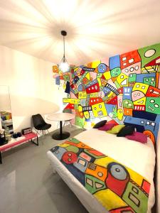 a bedroom with a bed with a colorful wall at Maison Du Vieux Panier Vieux Port in Marseille