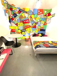 a bedroom with a bed with a colorful wall at Maison Du Vieux Panier Vieux Port in Marseille