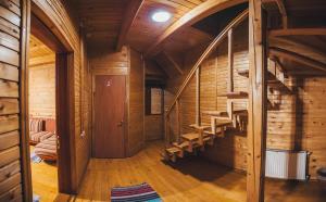a room with wooden walls and stairs in a cabin at Sanatoriy Karpatia in Shaian
