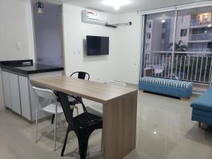 a kitchen with a table and chairs and a balcony at Piscina & Descanso - Puerto Azul- con todas las comodidades! in Ricaurte