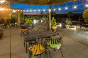 an outdoor patio with tables and chairs and lights at Holiday Inn Express Hotel & Suites North Sequim, an IHG Hotel in Sequim