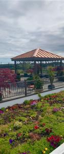 a garden area with flowers and a fence at Holiday Inn Express Hotel & Suites North Sequim, an IHG Hotel in Sequim