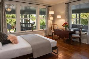 a bedroom with a bed and a desk with a table at Inn at the Gorge in Hood River