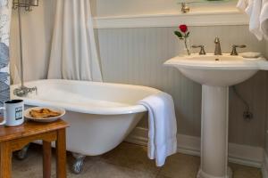 a bathroom with a sink and a bath tub and a sink at Inn at the Gorge in Hood River