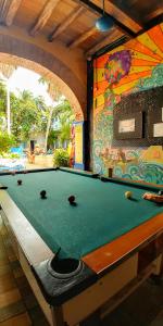 a billiard table in a room with a pool table at Media Luna Hostel Cartagena in Cartagena de Indias
