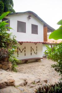 
a white and blue house with a large window at Mundo Nuevo Eco Lodge in Minca
