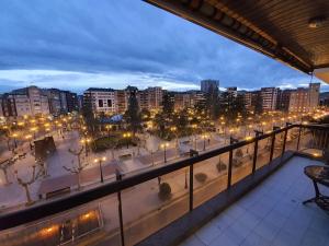 a balcony with a view of a city at night at El Mirador del Espolon in Logroño