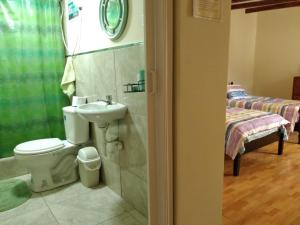 y baño con aseo y lavamanos. en ENHEBRA HOUSE, en Lima