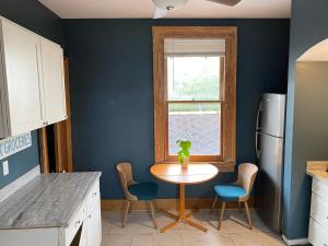 a kitchen with a table and chairs and a window at Uptown Treehouse in New Orleans +7 photos