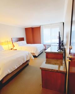 a hotel room with two beds and a flat screen tv at Holiday Inn Express Hotel & Suites Portland-Northwest Downtown, an IHG Hotel in Portland