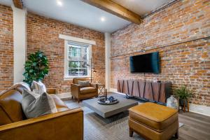 a living room with a brick wall at The St John in New Orleans