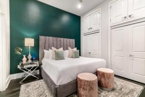 a bedroom with a bed and a green wall at The Pelican in New Orleans