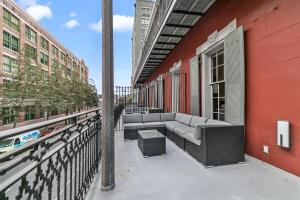 a balcony with a couch on the side of a building at The Pelican in New Orleans