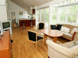 uma sala de estar com um sofá e uma mesa em 10 person holiday home in Hasle em Hasle
