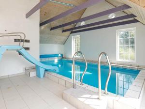 a swimming pool with a slide in a house at 14 person holiday home in Ulfborg in Husby