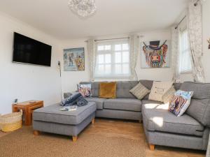 a living room with two couches and a tv at Morrane in Chacewater