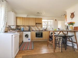 a kitchen with wooden cabinets and a counter top at Morrane in Chacewater