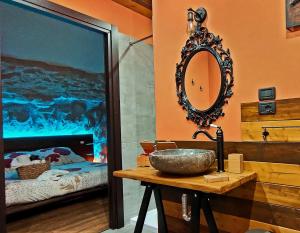 a bathroom with a sink and a mirror and a bed at Favola B&B in Pescara