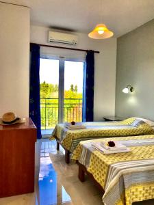 a bedroom with two beds and a window with a balcony at Room in Apartment - Banos Apartments And Swimming Pool in Roda